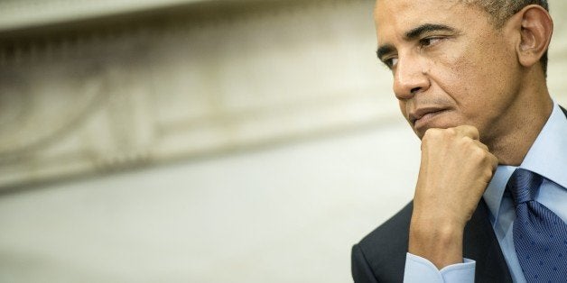 US President Barack Obama listens while Indian Prime Minister Narendra Modi makes a statement to the press after a meeting in