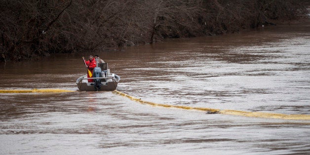 CHARLESTON, WV JANUARY 11, 2014:Emergency crew try to position booms to contain the chemical leak in the Elk River on Saturday, January 11, 2014 at the West Virginia American Water Company in Charleston, West Virginia.Ty Wright for the Washington Post