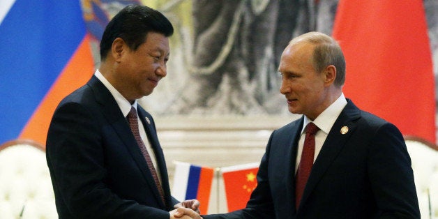 SHANGHAI, CHINA - MAY 21: President of Russia Vladimir Putin greets Chinese President Xi Jinping on May 21, 2014 in Shanghai, China. Russia and China signed a thirty-year contract for supply of gas. (Photo by Sasha Mordovets/Getty Images)