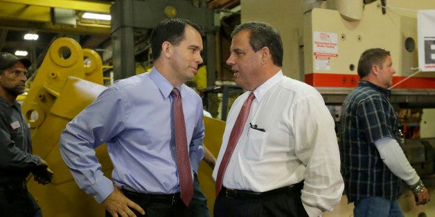 New Jersey Gov. Chris Christie, right, talks with Wisconsin Gov. Scott Walker as they tour Empire Bucket in Hudson, Wis., Monday, Sept. 29, 2014. Christie campaigned with Walker in Hudson Monday. (AP Photo/Ann Heisenfelt)