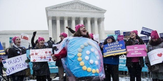 Activists rally against Hobby Lobby's choice to deny contraceptive healthcare coverage to its employees outside the Supreme Court March 25, 2014 in Washington, DC. The Supreme Court will hear arguments today if Hobby Lobby and other for profit corporations can refuse to cover contraceptive services in their employee's healthcare for religious reasons. AFP PHOTO/Brendan SMIALOWSKI (Photo credit should read BRENDAN SMIALOWSKI/AFP/Getty Images)