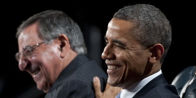 US President Barack Obama laughs with outgoing Defense Secretary Leon Panetta (L) during an Armed Forces Farewell Tribute in