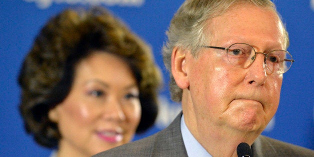 Kentucky Republican Senator Mitch McConnell listens to a question from reporters following a candidates forum at the Kentucky Farm Bureau Insurance headquarters, Wednesday, Aug. 20, 2014, in Louisville, Ky. (AP Photo/Timothy D. Easley)