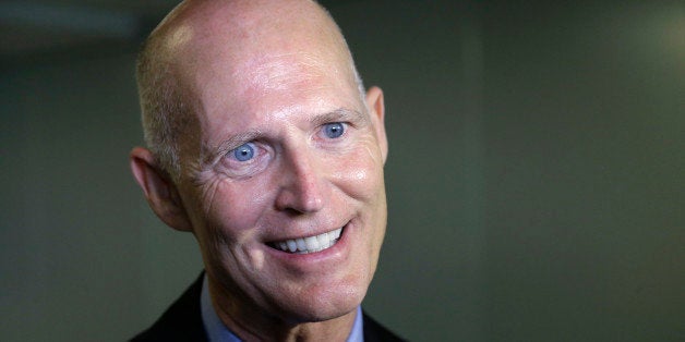 Florida Gov. Rick Scott speaks with members of the media, Monday, Sept. 22, 2014 at the University of Miami Miller School of Medicine, in Miami. (AP Photo/Wilfredo Lee)