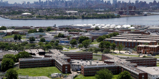 FILE- This June 20, 2014 file photo shows the Rikers Island jail with the New York skyline in the background. Over the past five years, there have been three deaths in New York City's jails in which inmates were alleged to have been fatally beaten by guards. Yet in none of those cases was anyone ever charged with a crime. (AP Photo/Seth Wenig, File)