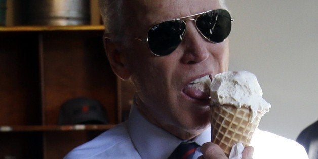 Vice President Joe Biden, right, gets ready to pay for an ice cream cone after a campaign rally for U.S. Sen. Jeff Merkley in Portland, Ore., Wednesday, Oct. 8, 2014. Biden was in Portland campaigning for Merkley who is being challenged by Republican Monica Wehby.(AP Photo/Don Ryan)