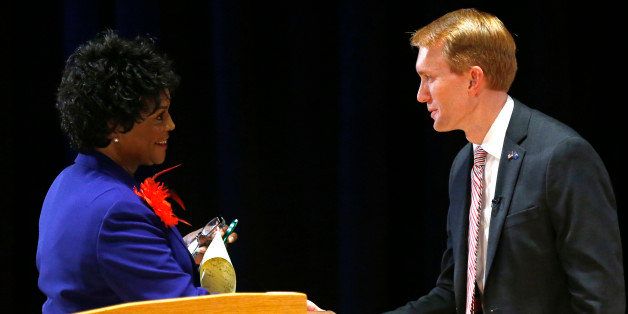 Democratic nominee for U.S. Senate, state Sen. Connie Johnson, left, and Republican nominee U.S. Rep. James Lankford, right, shake hands following a debate at Oklahoma State University, in Stillwater, Okla., Tuesday, Oct. 7, 2014. (AP Photo/Sue Ogrocki)