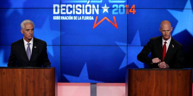 MIRAMAR, FL - OCTOBER 10: Former Florida Governor and Democratic candidate for Governor Charlie Crist (L) and Republican Florida Governor Rick Scott are seen as they wait to start their televised debate at NBCUniversal/Telemundo 51 on October 10, 2014 in Miramar, Florida. Governor Scott is facing off against Crist in the November 4, 2014 governors race. (Photo by Joe Raedle/Getty Images)