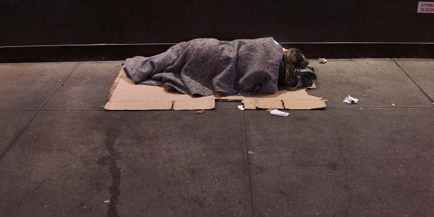 NEW YORK, NY - AUGUST 22: A homeless person sleeps on a Manhattan street on August 22, 2014 in New York City. According to the Department of Homeless Services, the number of homeless people in New York City has risen by more than 20,000 over the past five years. Newly elected Mayor Bill de Blasio, who ran as a liberal, has released a $41 billion plan to create 200,000 units of affordable housing across the city. Critics say the plan is too far off and that more immediate solutions need to be implemented to halt the increase of homelessness. (Photo by Spencer Platt/Getty Images)