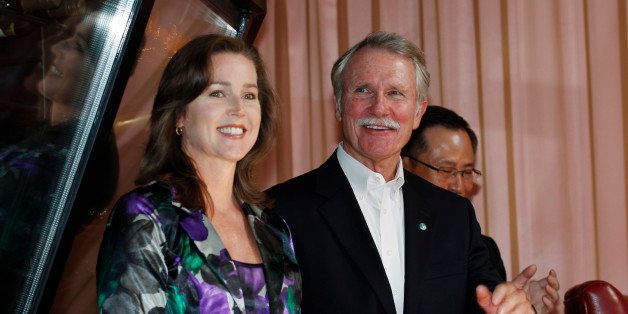 FILE - In this Sept. 13, 2011 file photo, Oregon Gov. John Kitzhaber, right, and his companion, Cylvia Hayes, react to a welcome from attendees at the awarding ceremony of the Enjoy Oregon Wine Fair in Tokyo. On Wednesday, Oct. 8, 2014, Portland's alternative weekly newspaper, the Willamette Week, reported that Kitzhaber's fiancee, Hayes, has used her role as an adviser to Kitzhaber to land contracts for her long-time job as a consultant on energy matters. (AP Photo/Hiro Komae, file)
