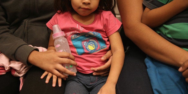 MCALLEN, TX - SEPTEMBER 08: Women and children sit in a holding cell at a U.S. Border Patrol processing center after being d
