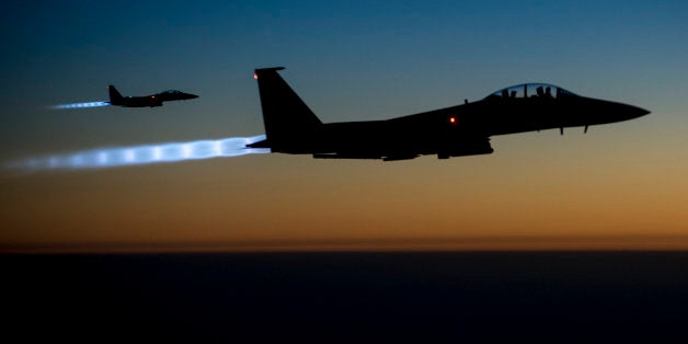 In this Tuesday, Sept. 23, 2014, photo, released by the U.S. Air Force, a pair of U.S. F-15E Strike Eagle flies over northern Iraq, after conducting airstrikes in Syria. U.S.-led coalition warplanes bombed oil installations and other facilities in territory controlled by Islamic State militants in eastern Syria on Friday, Sept. 26, 2014, taking aim for a second consecutive day at a key source of financing that has swelled the extremist group's coffers, activists said. (AP Photo/U.S. Air Force, Matthew Bruch)