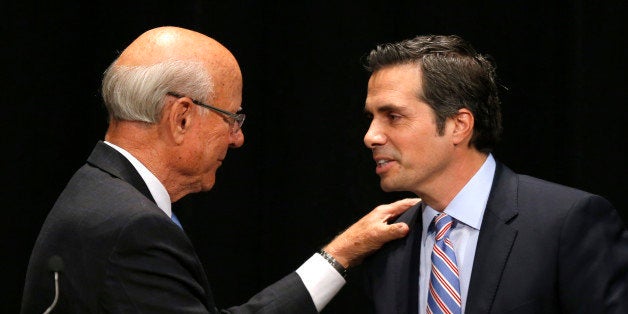 Sen. Pat Roberts, R-Kan., left, greets independent candidate Greg Orman, right, before a debate in Overland Park, Kan., Wednesday, Oct. 8, 2014. (AP Photo/Orlin Wagner)