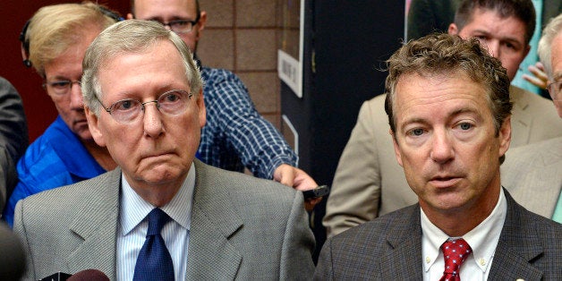 Kentucky Sens. Mitch McConnell, left, and Rand Paul speak with reporters following their appearance at the 50th annual Kentucky Country Ham Breakfast, Thursday, Aug. 22, 2013 at the Kentucky State Fairgrounds in Louisville, Ky. (AP Photo/Timothy D. Easley)