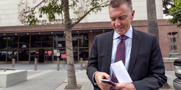 In this June 10, 2014, photo, Los Angeles Unified School District Superintendent John Deasy checks his phone outside the Stanley Mosk Courthouse, before the verdict in the Vergara v. California lawsuit in Los Angeles. Even before a California judge's scathing ruling against the state's teacher tenure policies, protections that make it harder to fire teachers had already been weakened in many states, and even removed altogether in a few places. (AP Photo/Damian Dovarganes)