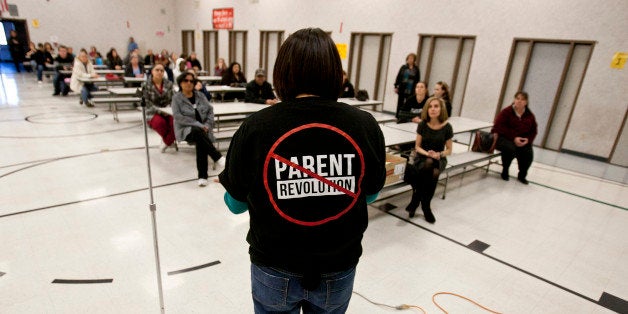 Desert Trails Elementary parents Chrissy Alvarado, right, address a group of parents against the takeover of the school by th