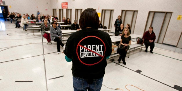 Desert Trails Elementary parents Chrissy Alvarado, right, address a group of parents against the takeover of the school by the Parents Unioin during a meeting, February 16, 2012, in Adelanto, California. The Parent Union is trying to use the new California 'Parent Trigger Law' to make changes at Desert Trails Elementary, but other parents are opposed to using the law to make the changes needed at the school because the law would remove the current facility and the school would become a Charter School. (Photo by Bret Hartman For The Washington Post via Getty Images)