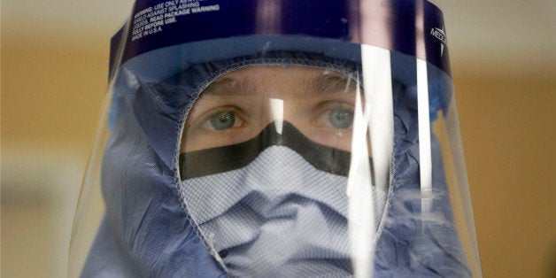 FILE - In this Oct. 16, 2014, file photo, Registered nurse Keene Roadman, stands fully dressed in personal protective equipment during a training class at the Rush University Medical Center, in Chicago. The Centers for Disease Control and Prevention released new guidelines Monday, Oct. 20, for how health workers should gear up to treat Ebola patients. (AP Photo/Charles Rex Arbogast, File)