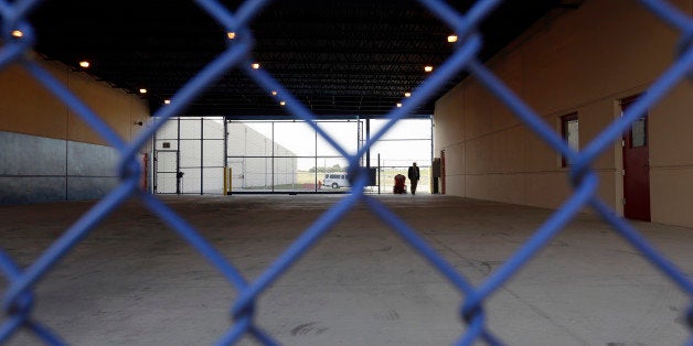 A secured entryway is seen at the Karnes County Residential Center in Karnes City, Texas on Thursday, July 31, 2014. Federal officials gave a tour of the South Texas immigration detention facility that has been retooled to house adults with children who have been apprehended at the border. (AP Photo/Eric Gay)