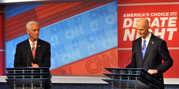 Democratic candidate Charlie Crist, left, and Republican Gov. Rick Scott wait for their live televised debate, Tuesday, Oct. 21, 2014 hosted by WJXT-TV and CNN at the Channel 4 studios in Jacksonville, Fla. (AP Photo/The Florida Times-Union, Will Dickey, Pool)
