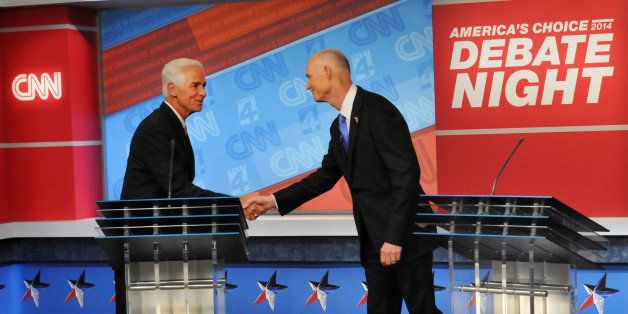 Democratic candidate Charlie Crist, left, and Republican Gov. Rick Scott shake hands before their live television debate, Tuesday, Oct. 21, 2014 hosted by WJXT-TV and CNN at the Channel 4 studios in Jacksonville, Fla. (AP Photo/The Florida Times-Union, Will Dickey, Pool)