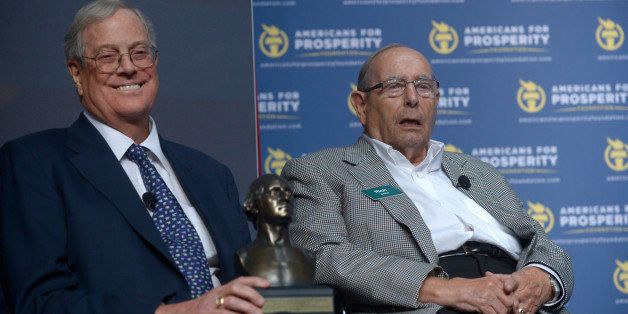 Americans for Prosperity Foundation Chairman David Koch, left, laughs as Amway Founder Rich DeVos addresses attendees of the Defending the American Dream Summit in Orlando, Fla., Friday, Aug. 30, 2013. DeVos was presented with the George Washington Award.(AP Photo/Phelan M. Ebenhack)