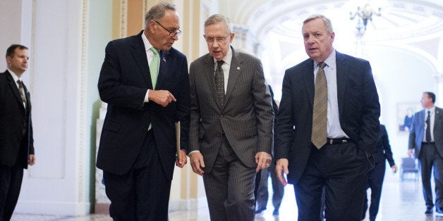 UNITED STATES - SEPTEMBER 11: From left, Sen. Charles Schumer, D-N.Y., Senate Majority Leader Harry Reid, D-Nev., and Senate Majority Whip Richard Durbin, D-Ill., make their way to a news conference in the Capitol on the administration's strategy for combating ISIL, September 11, 2014. (Photo By Tom Williams/CQ Roll Call)