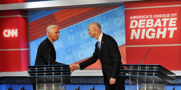 Democratic candidate Charlie Crist, left, and Republican Gov. Rick Scott shake hands before their live television debate, Tuesday, Oct. 21, 2014 hosted by WJXT-TV and CNN at the Channel 4 studios in Jacksonville, Fla. (AP Photo/The Florida Times-Union, Will Dickey, Pool)
