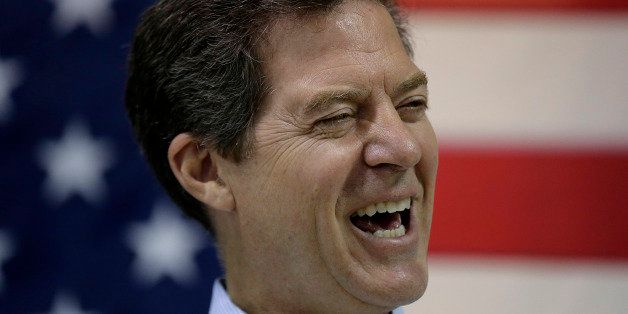 Kansas Gov. Sam Brownback talks to supporters during a campaign rally Monday, July 14, 2014, in Olathe, Kan. (AP Photo/Charlie Riedel)