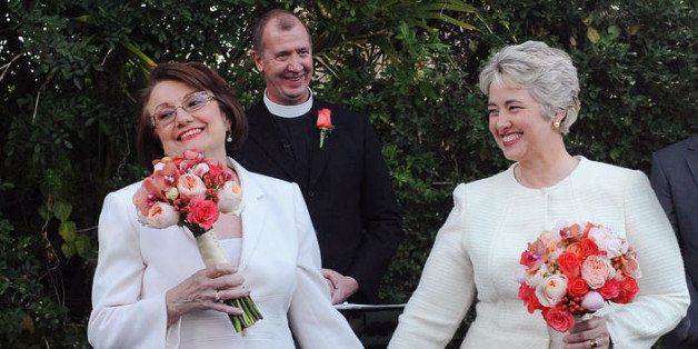 In this photo provided by the Houston mayor's office, Houston Mayor Annise Parker, right and her long-time partner, First Lady Kathy Hubbard, celebrate at their wedding Thursday, Jan 16, 1014 in Palm Springs, Calif. The ceremony was performed by the Rev. Paul Fromberg, rear, rector of St. Gregory of Nyssa Episcopal Church in San Francisco. (AP Photo/Houston Office of The Mayor, Richard Hartog)