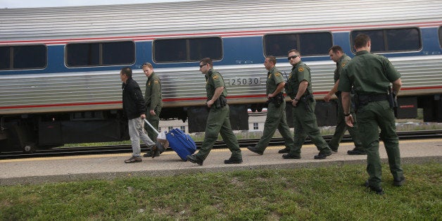 DEPEW, NY - JUNE 05: U.S. Border Patrol agents escort an individual without identification after checking for undocumented immigrants on an Amtrak train from Chicago to New York City on June 5, 2013 in Depew, New York. The agents set up a 24 hour check of transportation hubs in and around Buffalo. They said they received intelligence of undocumented immigrants passing through the area. The Border Patrol also monitors cross border traffic on the northern border between the United States and Canada. (Photo by John Moore/Getty Images)