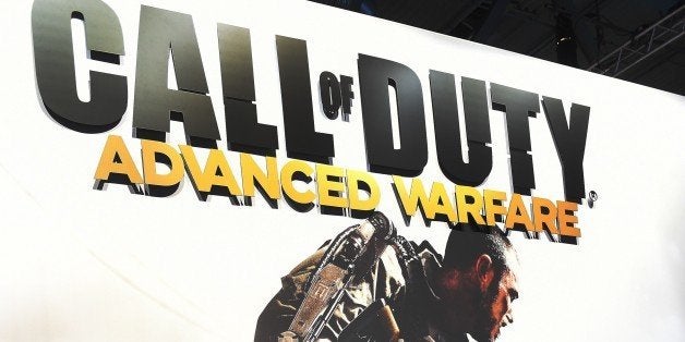 Visitors of the 'Gamescom' fair play the 'Call of duty' game on August 14, 2014 during the Gamescom fair in Cologne, western