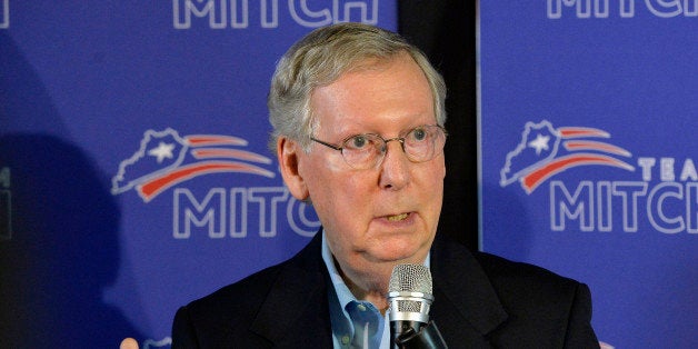 Kentucky Senator Mitch McConnell addresses the media during a press conference following McConnell's victory in the republican primary Friday, May 23, 2014, in Louisville, Ky. (AP Photo/Timothy D. Easley)