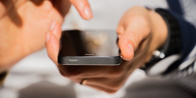 Woman with iPhone 5s checking all time his smartphone with internet connection. Internet addiction.