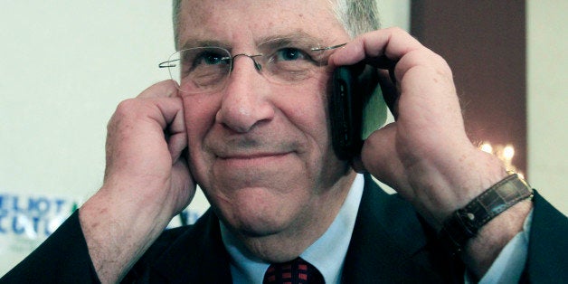 Independent gubernatorial candidate Eliot Cutler talks on the phone at his election night headquarters in Portland, Maine, on