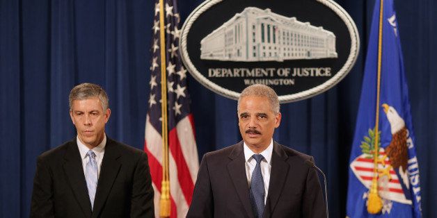 WASHINGTON, DC - MAY 13: U.S. Attorney General Eric Holder (R) and Education Secretary Arne Duncan hold a news conference at the Justice Department May 13, 2014 in Washington, DC. Holder announced that the Justice Department has reached a $60 million settlement with Sallie Mae after it was discovered the student load giant charged roughly 60,000 military service members excessive interest rates on their education loans. (Photo by Chip Somodevilla/Getty Images)