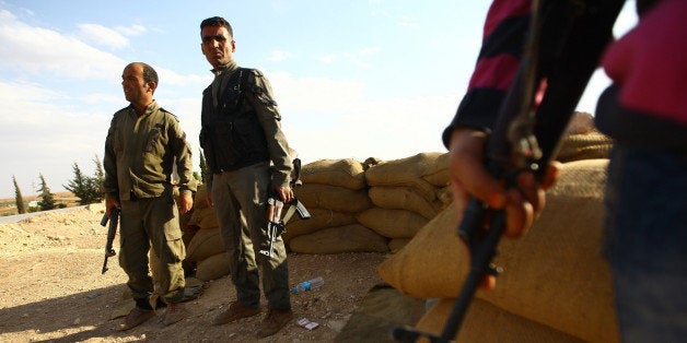 ALEPPO, SYRIA - SEPTEMBER 25: Free Syrian Army rebel fighters deploy in fight against Islamic State of Iraq and the Levant (ISIL) militants to retrieve the villages in Ayn al-Arab district of Aleppo Governorate in northern Syria on September 25, 2014. (Photo by Ensar Ozdemir/Anadolu Agency/Getty Images)