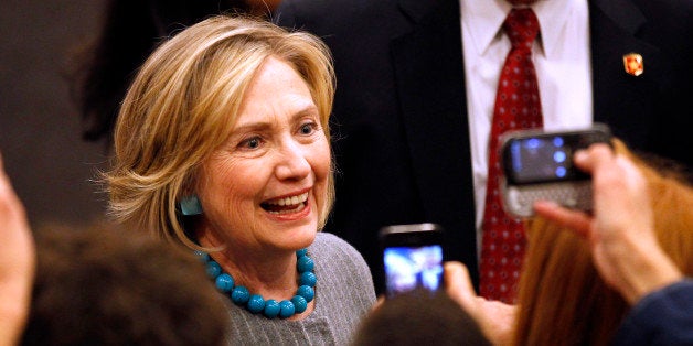 Hillary Rodham Clinton shakes hands with the crowd after campaigning for Democratic gubernatorial nominee Gina Raimondo, not pictured, at Rhode Island College in Providence, R.I., Friday Oct. 24, 2014. (AP Photo/Stew Milne)