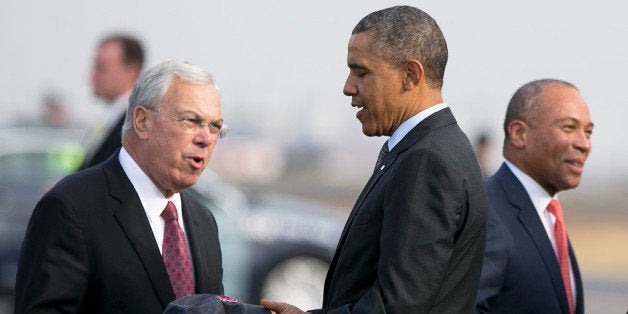 BOSTON - OCTOBER 30: U.S. President Barack Obama received a Boston Red Sox hat from Boston Mayor Thomas Menino while Governor Deval Patrick greeted Rep. John Tierney after he exited Air Force One after landing at Boston Logan Airport on his way to Faneuil Hall to bolster support for his national health care law in Boston, Mass. on Wednesday, October 30, 2013. (Photo by Yoon S. Byun/The Boston Globe via Getty Images)