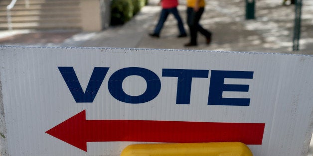 MIAMI, FL - OCTOBER 28: A sign points to the early voting station setup at the Government building on October 28, 2014 in Mi