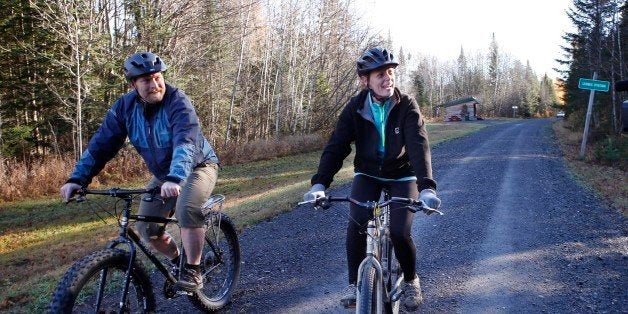 Nurse Kaci Hickox, right, and her boyfriend, Ted Wilbur ride bikes on a trail near her home in Fort Kent, Maine, Thursday, Oc