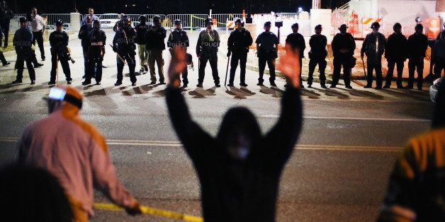 FERGUSON, MO - OCTOBER 22: Police face off with demonstrators outside the police station as protests continue in the wake of 18-year-old Michael Brown's death on October 22, 2014 in Ferguson, Missouri. Several days of civil unrest followed the August 9 shooting death of Brown by Ferguson police officer Darren Wilson. Today's protest was scheduled to coincide with a day of action planned to take place nationwide to draw attention to police brutality. (Photo by Scott Olson/Getty Images)
