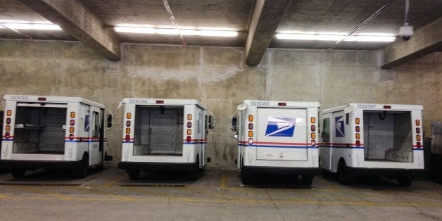 Santa Monica, Ca - October 20, 2014. Four parked U.S. Postal Service mail trucks.