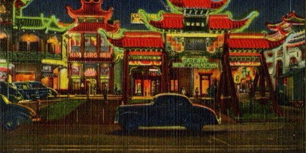 UNITED STATES - CIRCA 1943: Postcard view of Chinatown at night showing the building lit by neon. Vintage automobiles are on