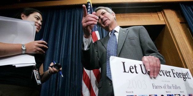 WASHINGTON - JULY 28: U.S. Rep. Walter Jones (R-NC) (R) talks to a reporter after a news conference on Capitol Hill July 28, 2005 in Washington, DC. Congressmen talked about H.J.Res.55., legislation titled 'Homeward Bound' that requires President George W. Bush to develop and implement a plan for the withdrawal of U.S. armed forces from Iraq. Pictured on a poster are U.S. servicemen killed in Iraq. (Photo by Alex Wong/Getty Images)