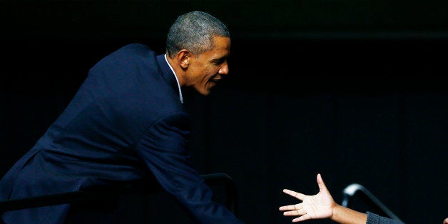 President Barack Obama meets with audience members as he campaigns for Pennsylvania Democratic gubernatorial candidate Tom Wolf Sunday, Nov. 2, 2014, at Temple University in Philadelphia. (AP Photo/Matt Rourke)