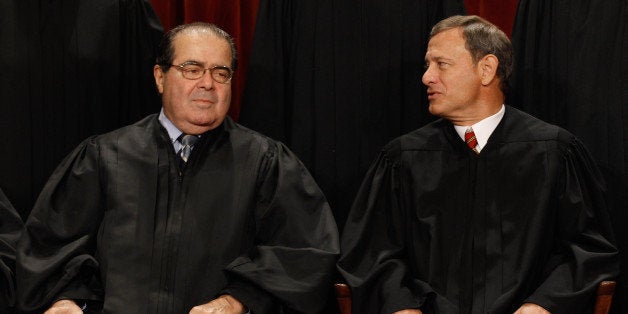 WASHINGTON - OCTOBER 08: U.S. Supreme Court Associate Justice Antonin Scalia (L) and Chief Justice John Roberts talk while posing for photographs in the East Conference Room at the Supreme Court building October 8, 2010 in Washington, DC. This is the first time in history that three women are simultaneously serving on the court. (Photo by Chip Somodevilla/Getty Images)