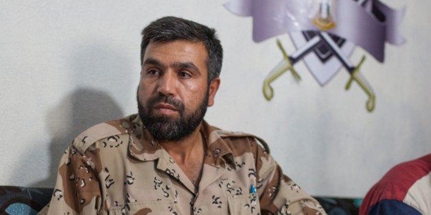 Jamal Maarouf, commander of the Free Syrian Army's Syrian Martyrs' Brigade, listens to a question during an interview with journalists at an undisclosed location in the northwestern province of Idlib on June 16, 2013. World leaders arrived in Northern Ireland for the G8 summit on June 17, looking to put pressure on Russia to back away from its support of Syrian President Bashar al-Assad. AFP PHOTO/DANIEL LEAL-OLIVAS (Photo credit should read DANIEL LEAL-OLIVAS/AFP/Getty Images)