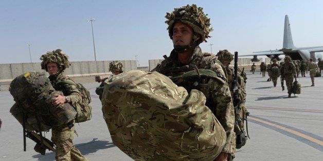 British soldiers walk with their gear after arriving in Kandahar on October 27, 2014, as British and US forces withdraw from the Camp Bastion-Leatherneck complex in Helmand province. British forces October 26 handed over formal control of their last base in Afghanistan to Afghan forces, ending combat operations in the country after 13 years which cost hundreds of lives. The Union Jack was lowered at Camp Bastion in the southern province of Helmand, while the Stars and Stripes came down at the adjacent Camp Leatherneck -- the last US Marine base in the country. AFP PHOTO/WAKIL KOHSAR (Photo credit should read WAKIL KOHSAR/AFP/Getty Images)