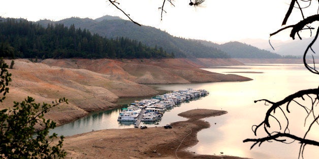 In this photo taken Sept. 17, 2014, house boats are docked in the low water at Lake Shasta's Bay Bridge...